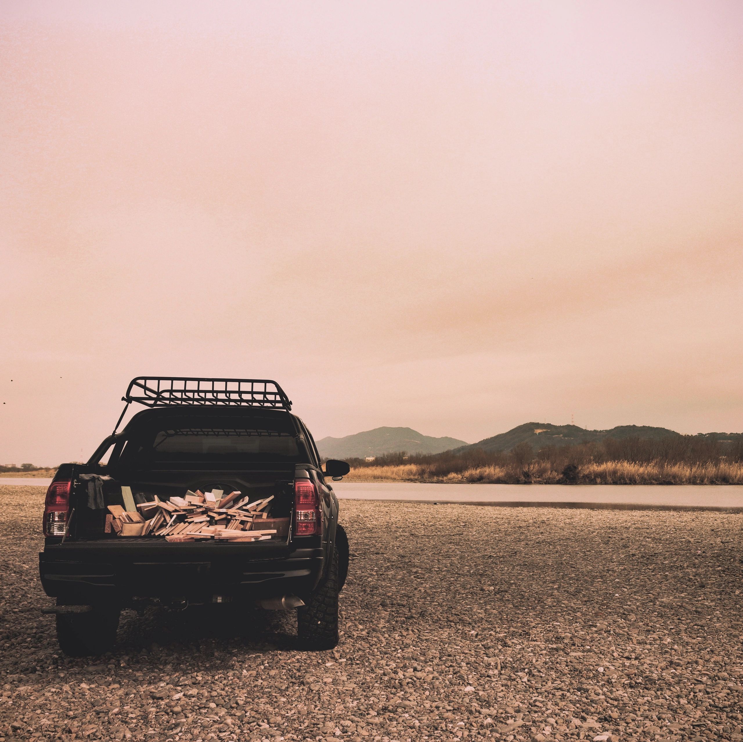 SUV parked near scenic landscape, representing outstation travel