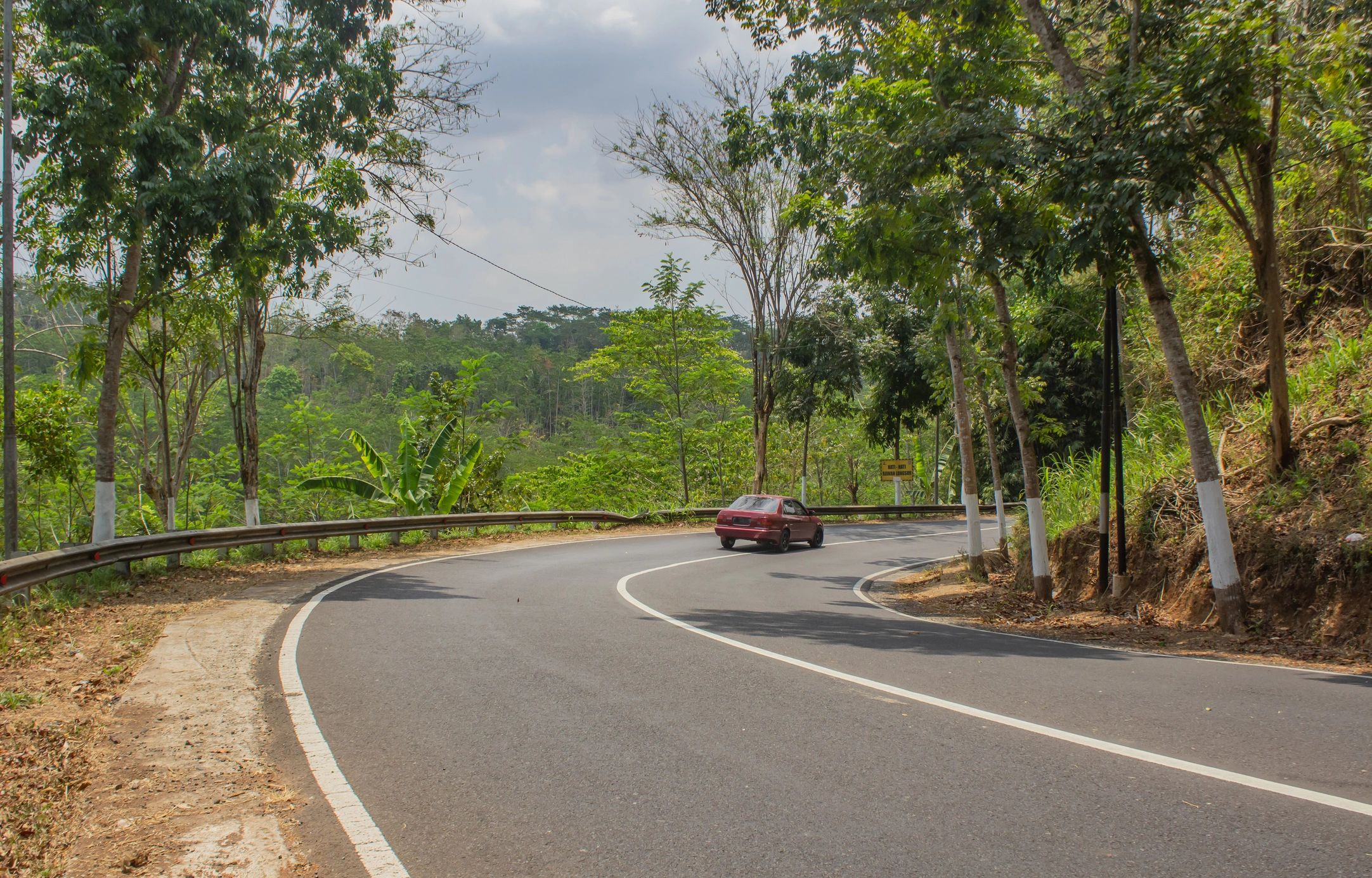 Car driving on a scenic road for outstation travel