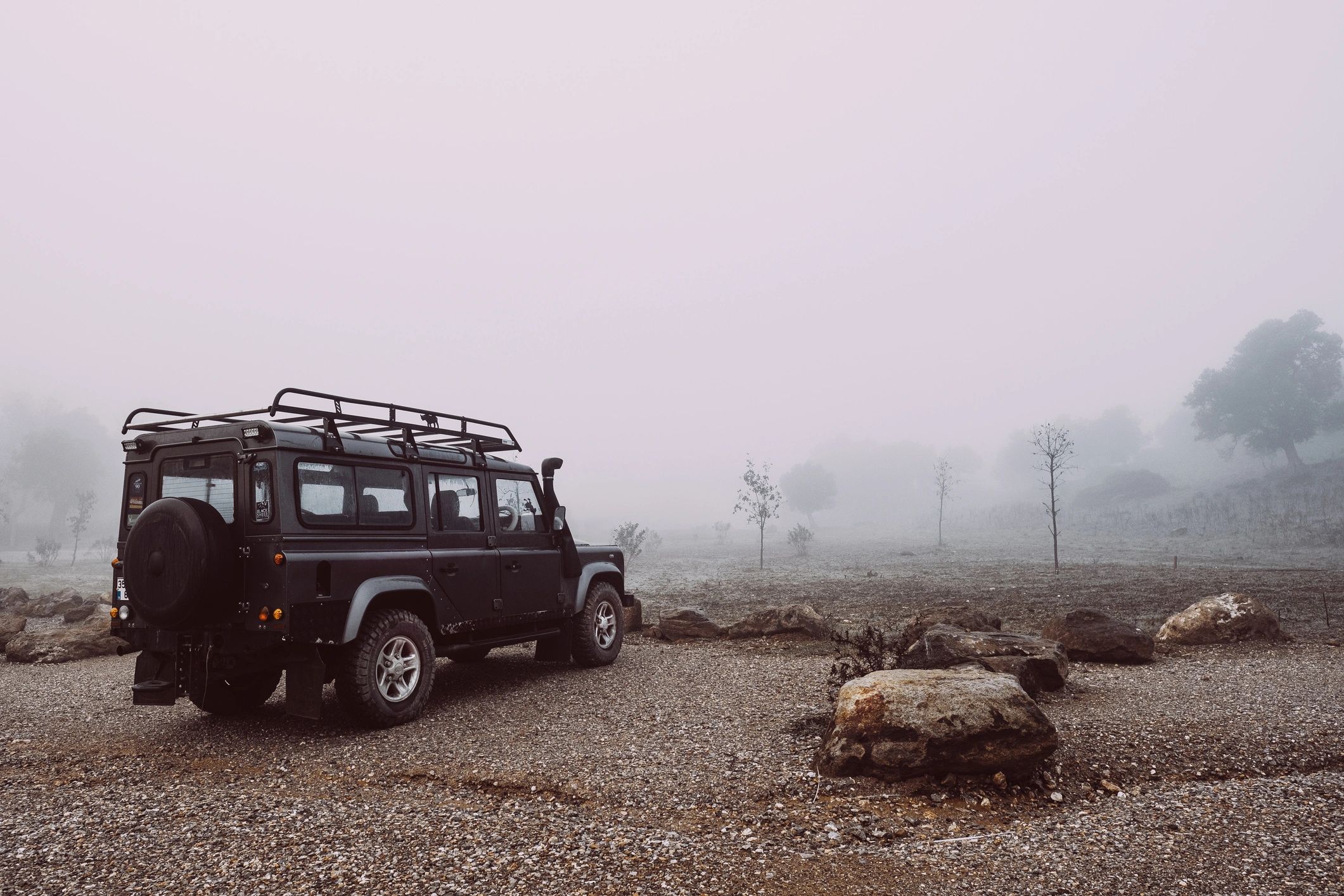 Premium SUV on a scenic road, representing executive travel